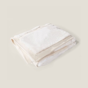 Luxury plain white blanket in high-end natural materials by Maison Norki