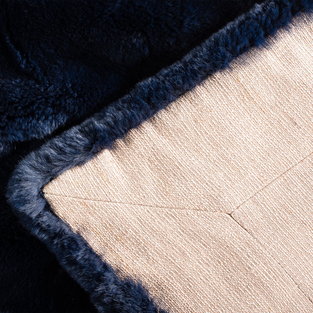 Haute couture lining and careful finishing for this navy blue throw lined with beige