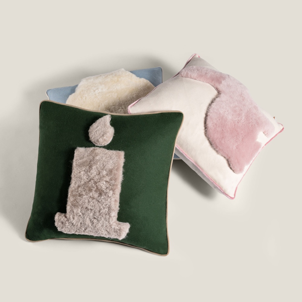 Set of high-end cushions matching soft colors and abstract pattern