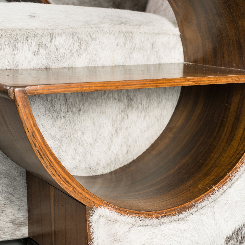 Luxurious carpentry work for the armrests of this vintage hide armchair