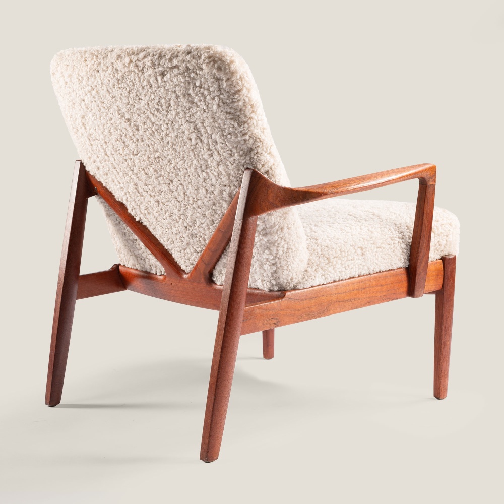 High-end armchair in beige shearling and back in solid wood