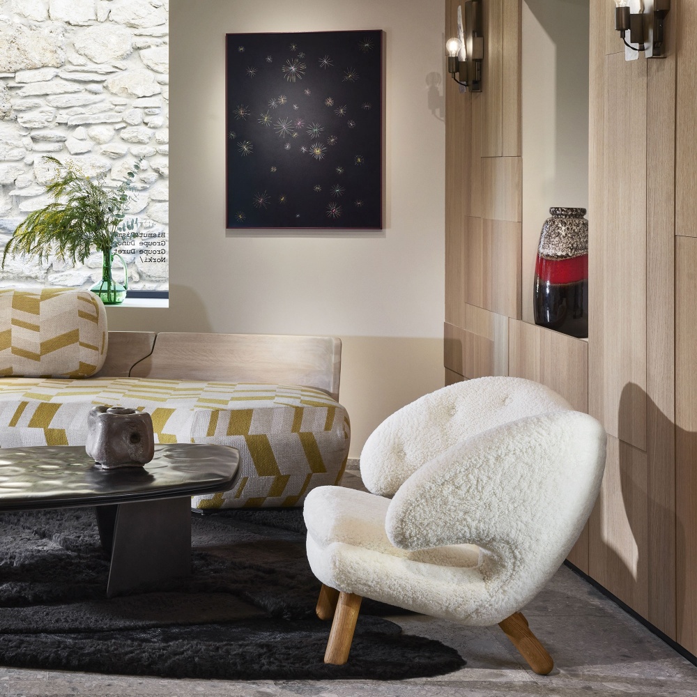 Interior design of a contemporary living room with vintage furniture by Finn Juhl and a luxury black carpet