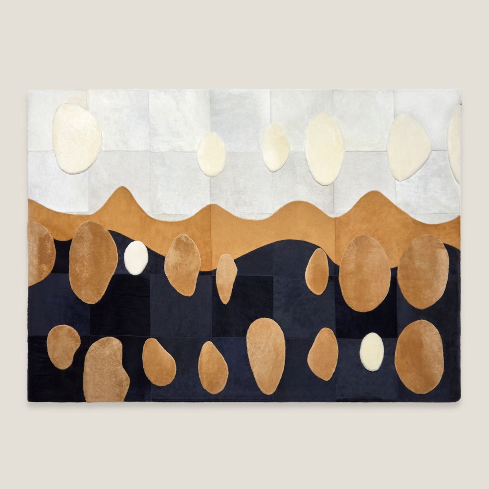 Large rectangular cowhide and wool rug by La Maison Norki.