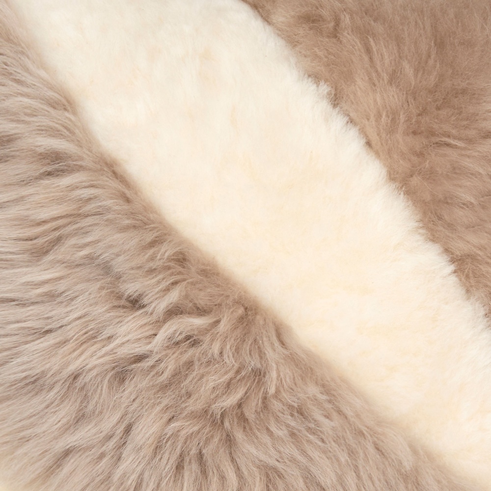 Luxurious, haute couture finishes for this elegant white and linen cushion in sheepskin and shearling.