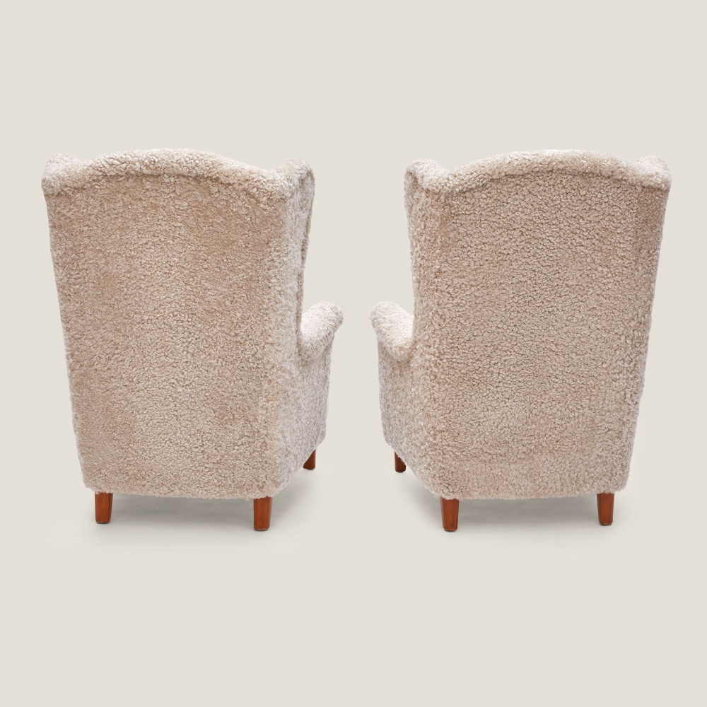 A pair of large reading armchairs by Carl Malmsten, a famous 20th-century Scandinavian designer.