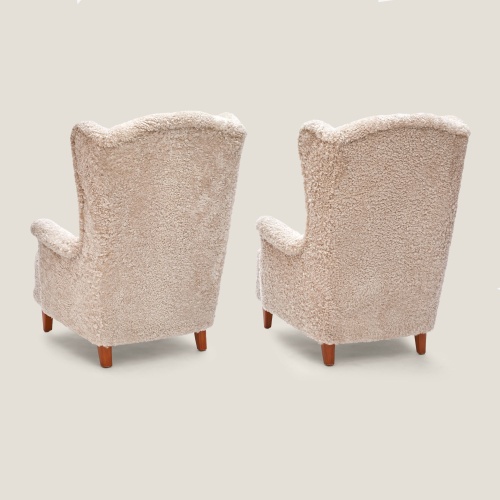 Two large luxury vintage armchairs reupholstered by the Norki workshop in noble shearling.