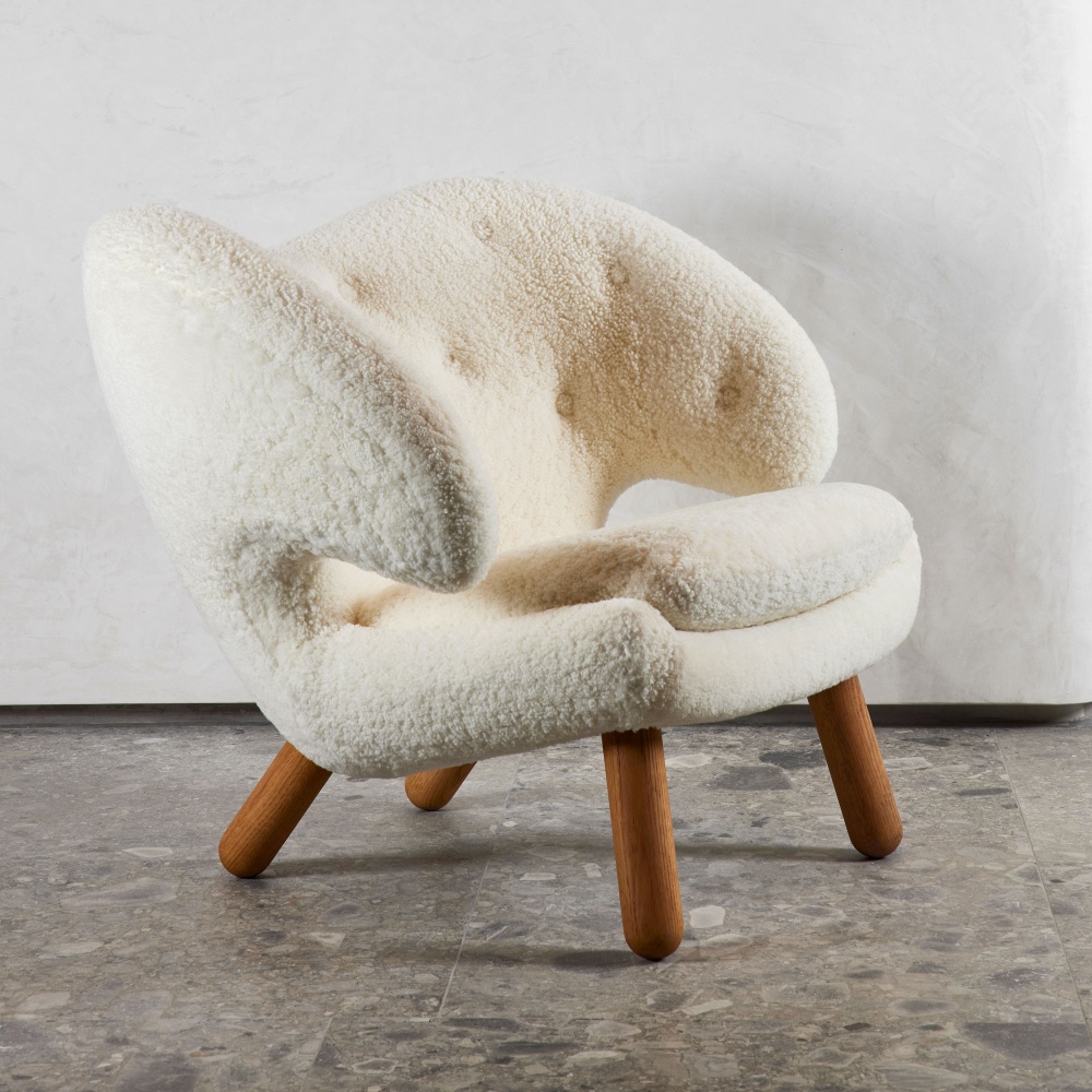 Vintage Collectible, collect timeless pieces like this white Pelican armchair by Finn Juhl.