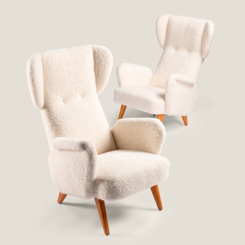 Two armchairs in white French curly shearling by 20th century Scandinavian designer Carl Gustaf Hiort.