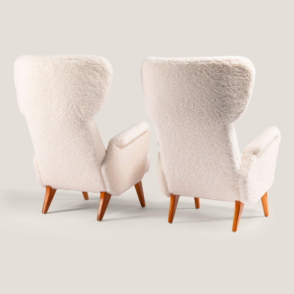 Two large luxury vintage armchairs reupholstered by Atelier Norki in noble natural curly shearling.