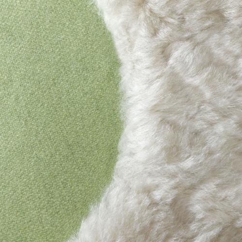 Close-up of the beige sheepskin boot pattern on the cushion, showing the texture and colors.