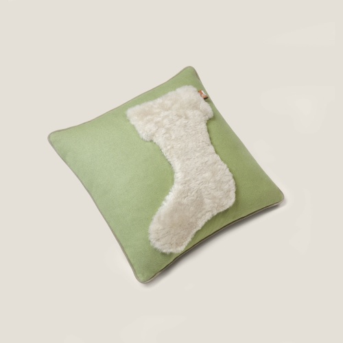 Playful cushion in leather and green fabric, perfect for a child's bedroom.