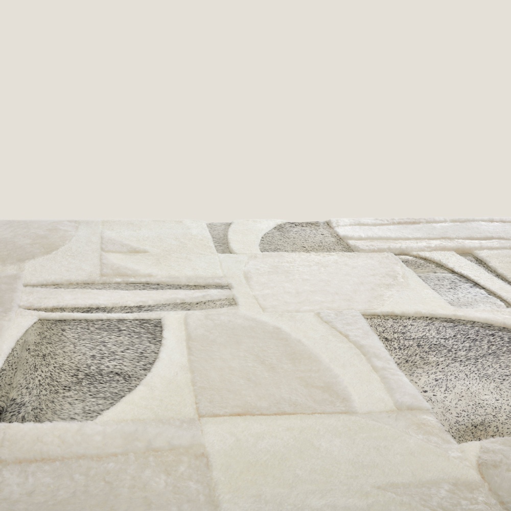 Focus on the grey/white mottled cowhide of our comfortable Zima rug.