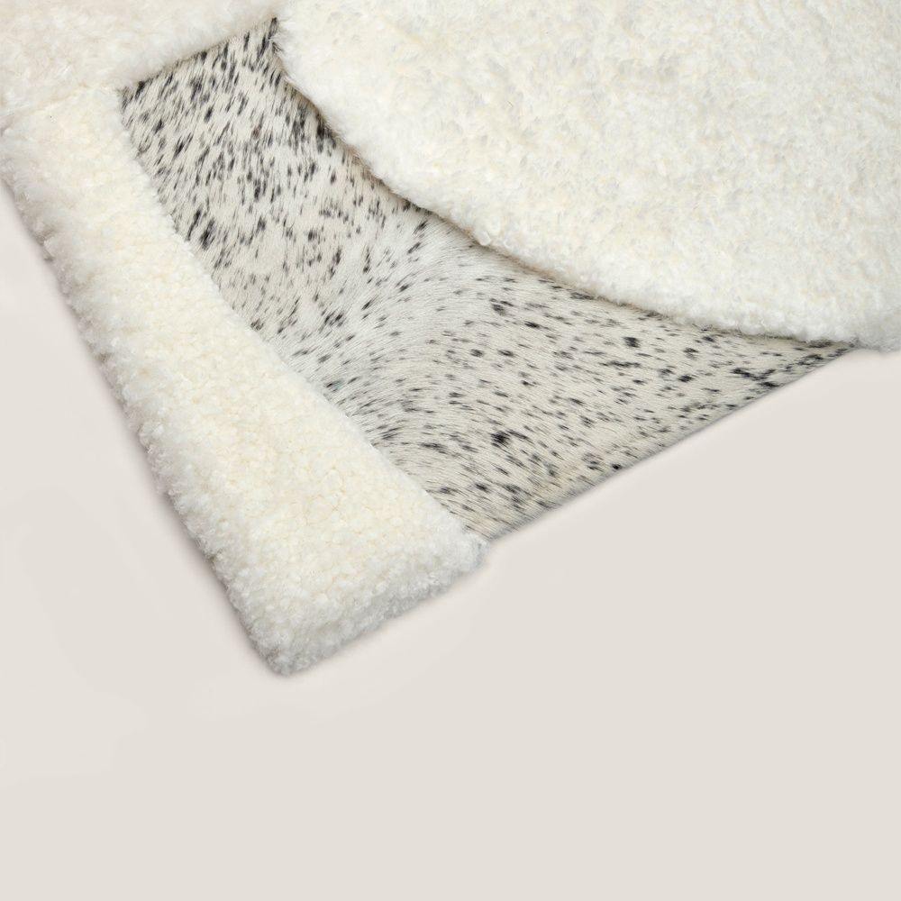 Focus on the grey/white mottled cowhide of our comfortable Zima rug.