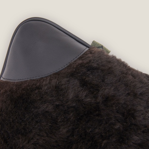 Focus on one ear of the Sarafan by Norki cushion, a black leather ear on the 4 corners of the cushion.