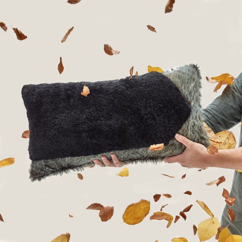 Our rectangle Forest cushion, a luxury cushion in blue/green cowhide and natural black sheepskin.