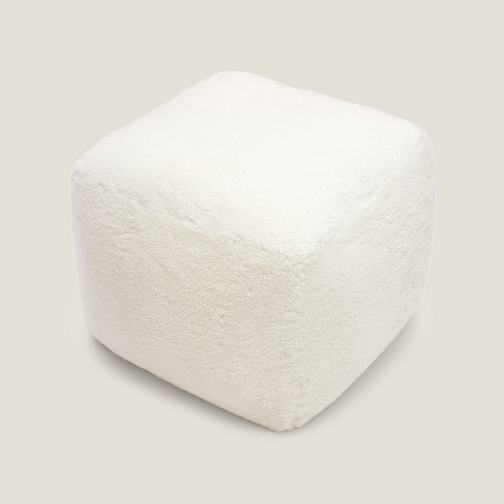 A luxury, made-to-measure footstool in white terrycloth for a modern, designer interior.