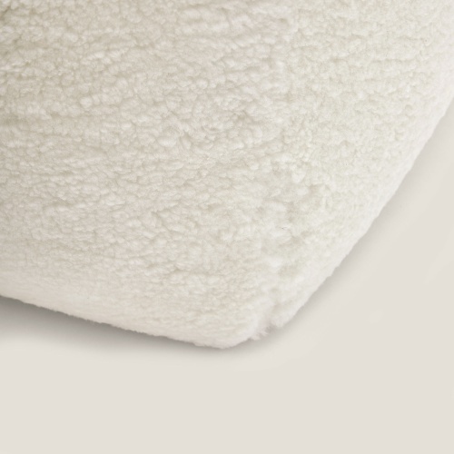 Detail of the top-of-the-range wool hide used for this small white designer ottoman.