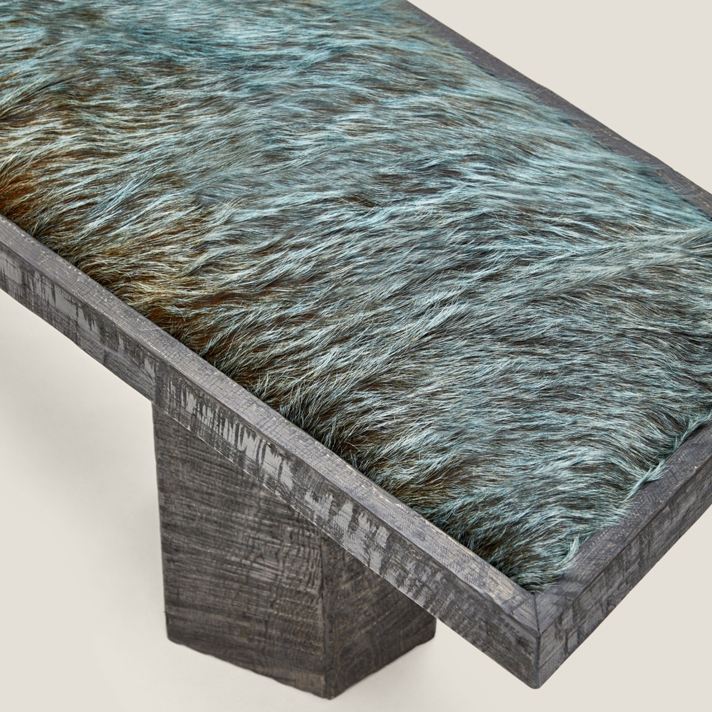 Focus on blue/green-tinted cowhide, a noble material that makes this bench exclusive.