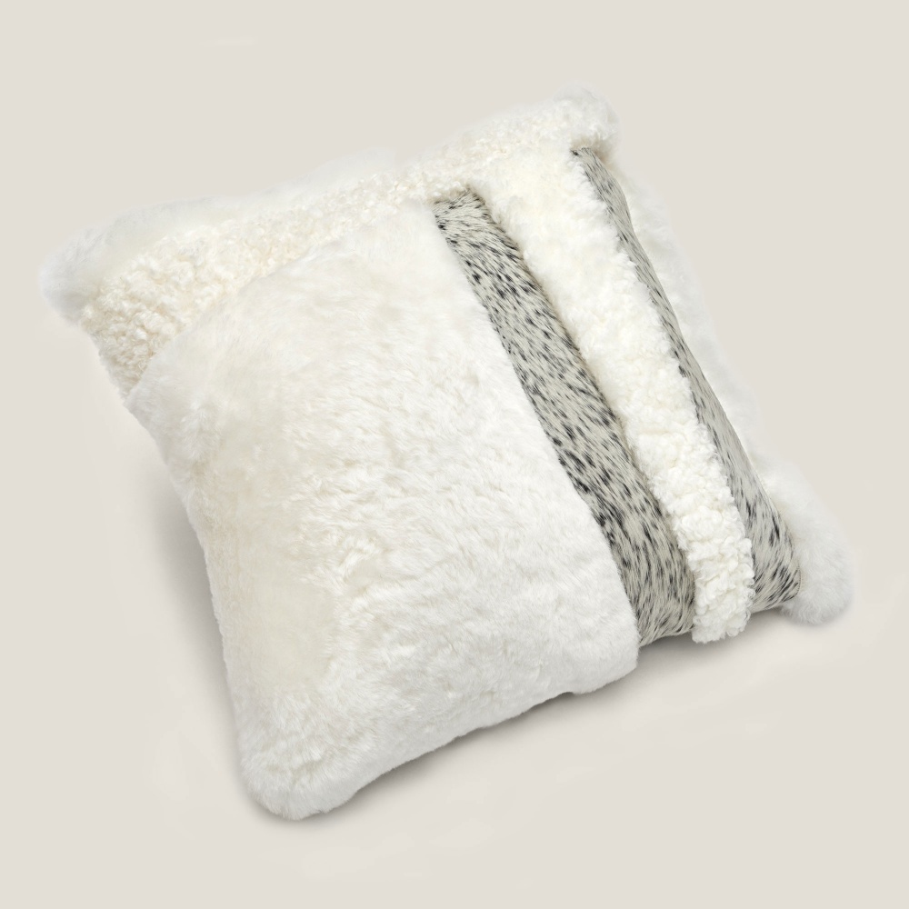 Square Zima cushion in white cowhide with geometric pattern in grey/white mottled cowhide.