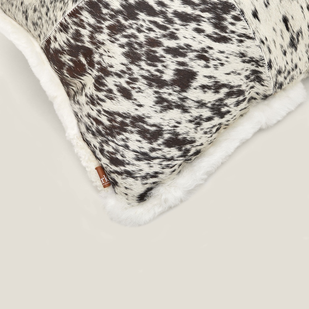 Details of the grey/white mottled cowhide of the square Zima cushion.