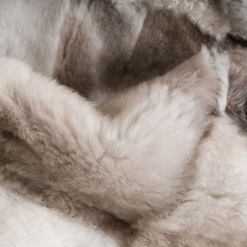 White, cream and brown real hide throw, comfortable and soft.