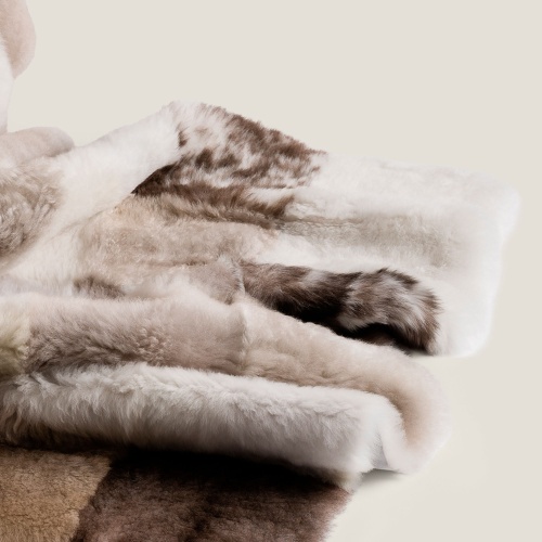 An ultra-soft throw made from real fur in white, beige and brown.