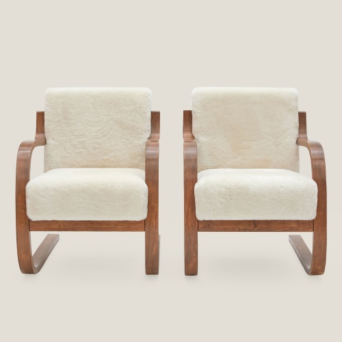 Front view of a pair of vintage Alvar Aalto armchairs.