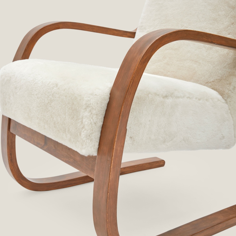 An armchair with birch armrests for optimum comfort.