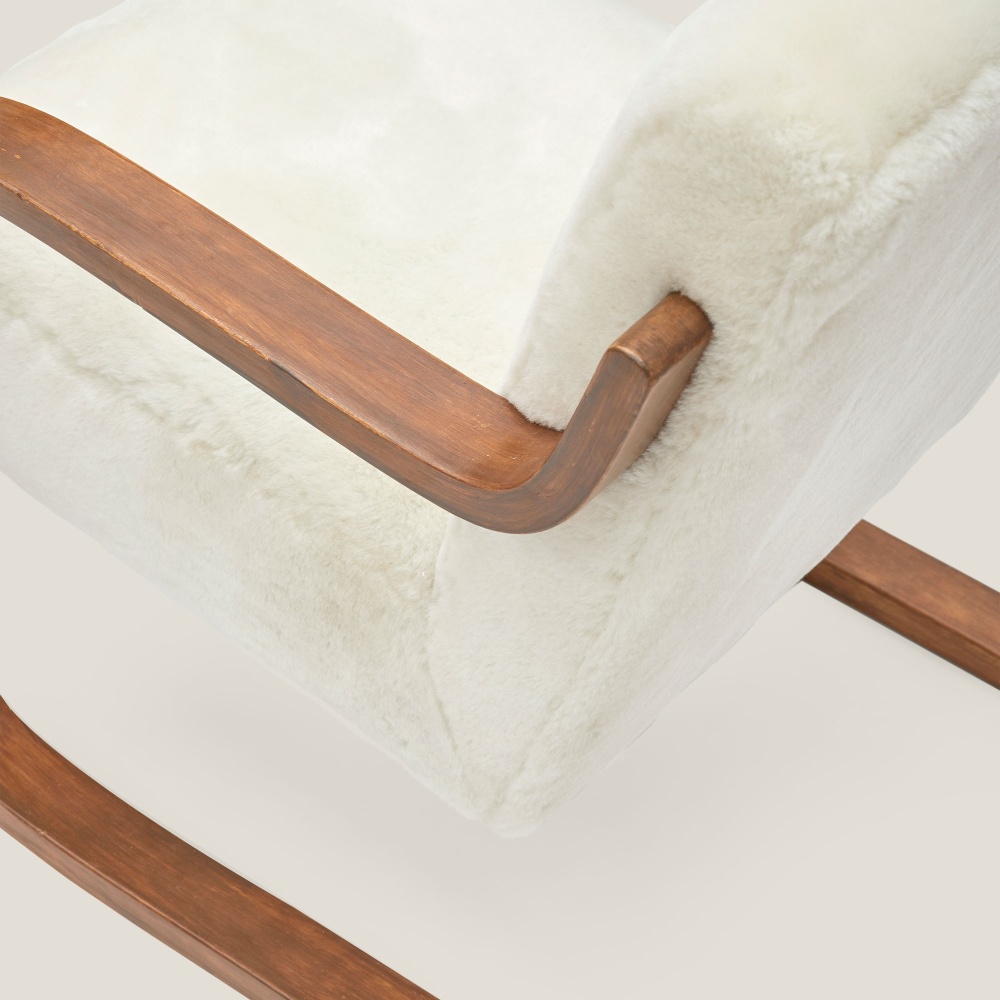 Focus on the details of the sheepskin that covers these magnificent vintage Alvar Aalto armchairs.