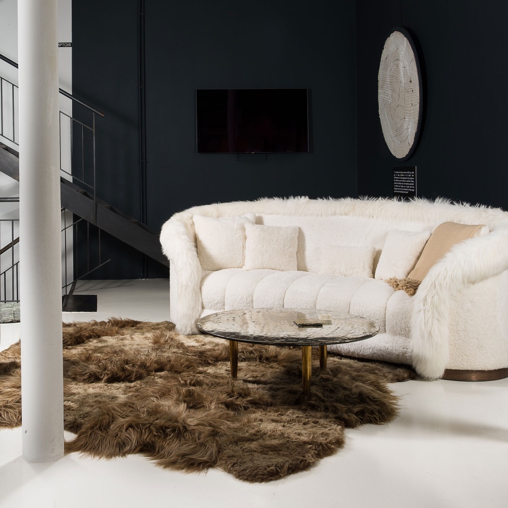 A white cloud sofa and a designer rug for opulent, luxurious decor.