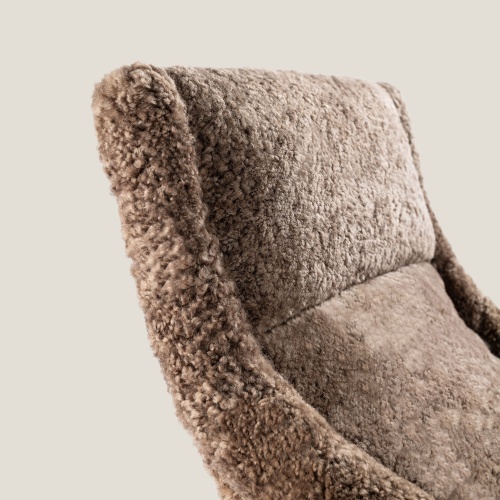 Siesta armchair covered in soft sand sheepskin with a matching soft ottoman, a creation by Svante Skogh.