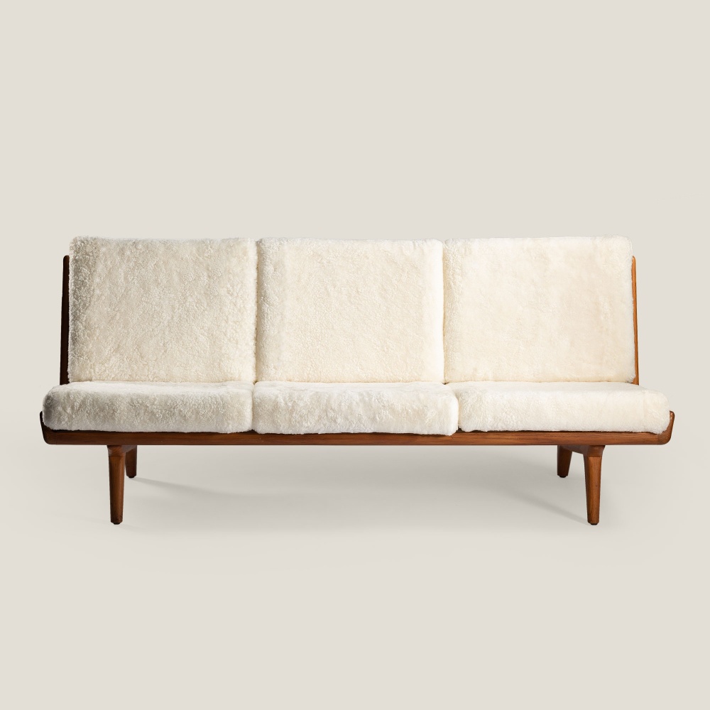 Vintage 3-seater sofa with teak structure and white curly wool back and seat cushions.