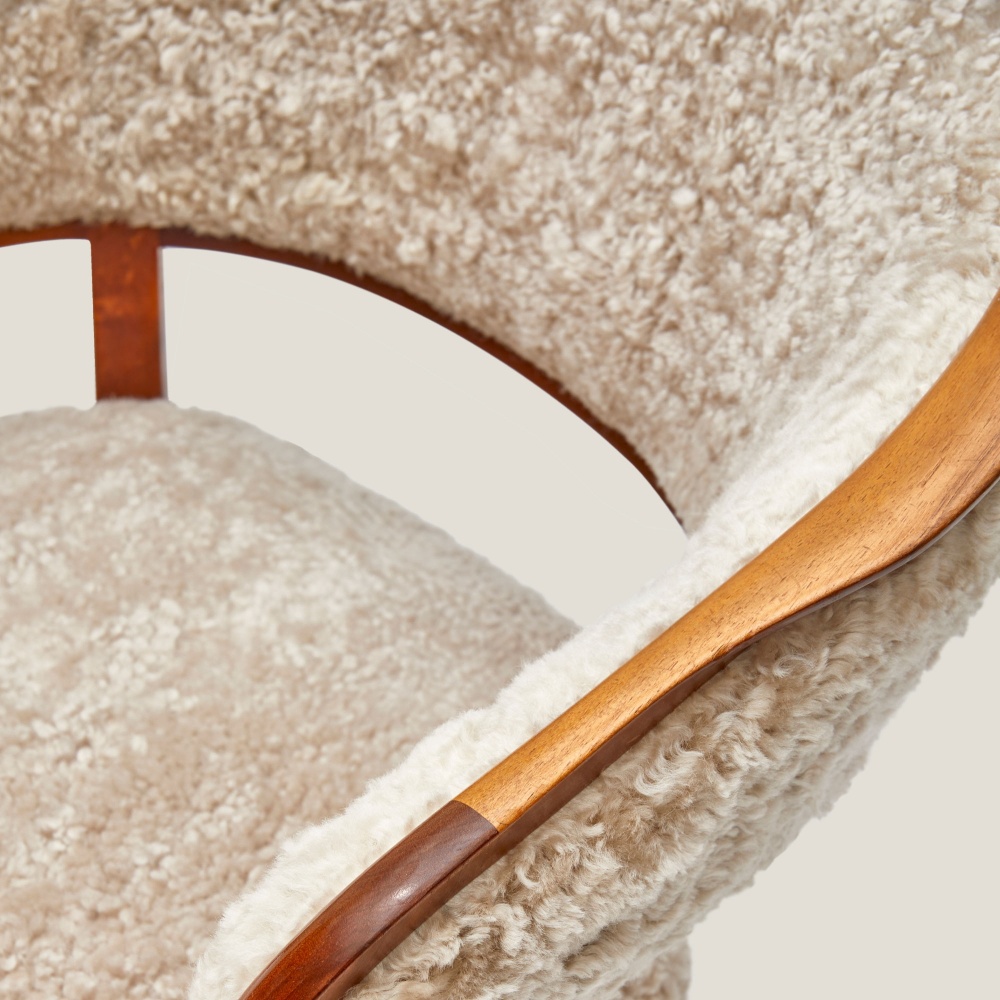 Detail of the curved backrest of the Lata Greven chairs in the klismos style.