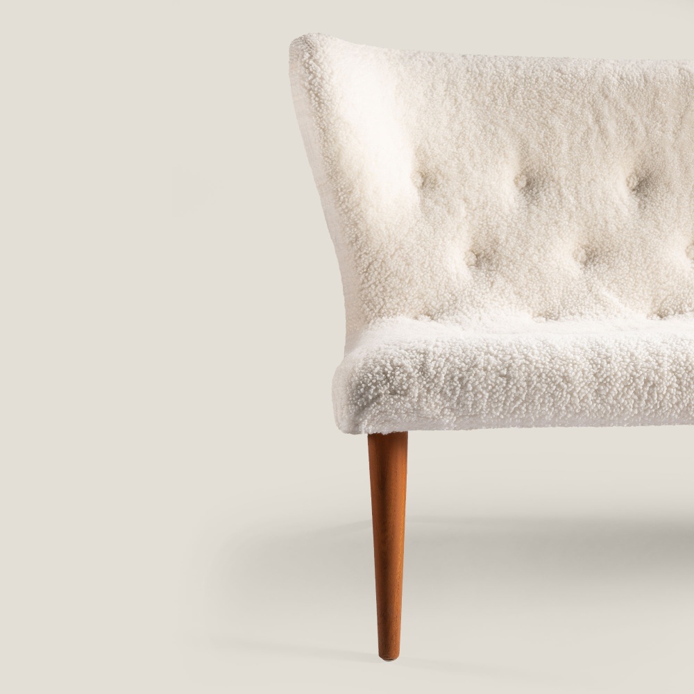 Small white sofa in curly shearling, Scandinavian design.