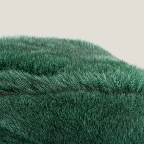 A close-up of the emerald green hue of the natural fur throw.