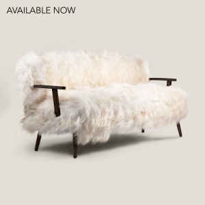 Charming sofa upholstered in long-haired white sheepskin with attractive black-stained solid oak legs and arms.