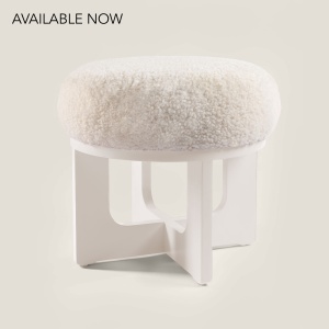 Shop a small white Norki pouf in lacquered wood and luxurious sheepskin for comfortable seating.