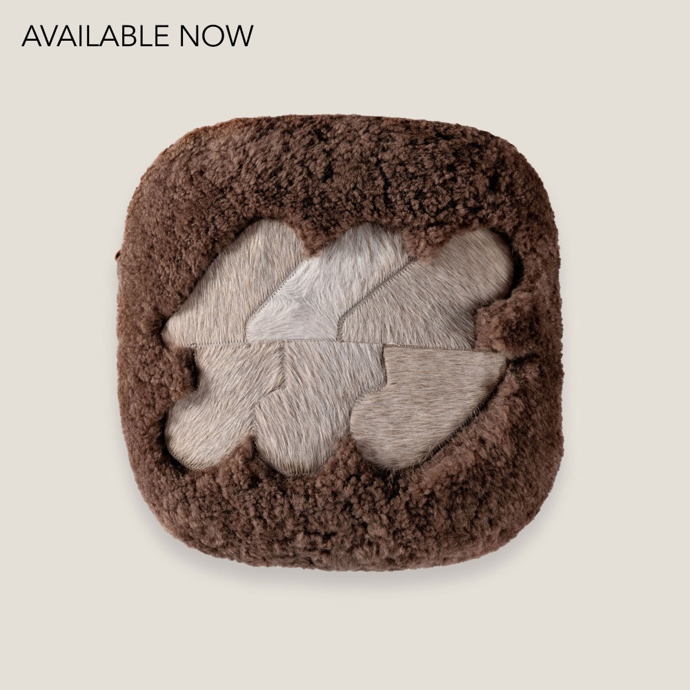 Chocolate-tinted Australian curly shearling cushion with a centered beige pattern by Norki.