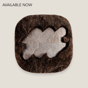 High-end cushion in dark brown shearling and beige cowhide by Norki workshops.